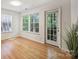 Well-lit room with neutral walls, windows, and a door leading to the exterior at 6016 Gray Gate Ln # C, Charlotte, NC 28210