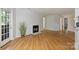 Well-lit living room highlighting the fireplace, hardwood floors, and an open floor plan at 6016 Gray Gate Ln # C, Charlotte, NC 28210
