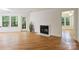 Spacious living room filled with natural light from the windows, a fireplace, and hardwood flooring at 6016 Gray Gate Ln # C, Charlotte, NC 28210