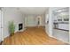 Bright living room showcasing a fireplace and view of the modern kitchen with stainless appliances at 6016 Gray Gate Ln # C, Charlotte, NC 28210