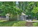 Community pool house surrounded by a landscaped yard and mature trees at 6016 Gray Gate Ln # C, Charlotte, NC 28210