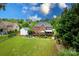 Spacious backyard featuring lush landscaping, a deck, patio with firepit and a well-manicured lawn at 6202 Pumpernickel Ln, Wesley Chapel, NC 28110