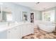 Bathroom with a soaking tub, double sinks, and decorative floors at 6202 Pumpernickel Ln, Wesley Chapel, NC 28110