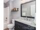 Bathroom with dark wood cabinets, a single sink and a shower and bathtub combination at 6202 Pumpernickel Ln, Wesley Chapel, NC 28110