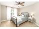 Neutral bedroom with a light grey bed, curtains, and carpet at 6202 Pumpernickel Ln, Wesley Chapel, NC 28110