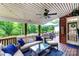 Covered deck area with comfortable seating, table, ceiling fan and an outdoor dining area at 6202 Pumpernickel Ln, Wesley Chapel, NC 28110