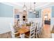 Formal dining room with wainscoting, wooden table, and pendant lighting at 6202 Pumpernickel Ln, Wesley Chapel, NC 28110