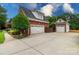 Featuring a spacious three-car garage and a basketball hoop on a large driveway at 6202 Pumpernickel Ln, Wesley Chapel, NC 28110