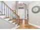 Bright foyer with wood floors, staircase, and elegant chandelier at 6202 Pumpernickel Ln, Wesley Chapel, NC 28110