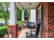 Relaxing front porch featuring a swing and rocking chair, perfect for enjoying peaceful moments at 6202 Pumpernickel Ln, Wesley Chapel, NC 28110