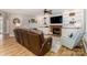 Cozy living room with built-in shelves, fireplace, and leather seating at 6202 Pumpernickel Ln, Wesley Chapel, NC 28110