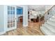 Open living area featuring French doors, hardwood floors, and a staircase at 6202 Pumpernickel Ln, Wesley Chapel, NC 28110