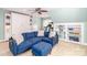 Comfortable living room featuring a blue couch, built-in shelves, and a ceiling fan at 6202 Pumpernickel Ln, Wesley Chapel, NC 28110