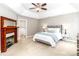 Elegant main bedroom featuring a fireplace, tray ceiling, and stylish decor, perfect for relaxation at 6202 Pumpernickel Ln, Wesley Chapel, NC 28110