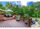 Deck features an outdoor dining area, a lush green yard, and manicured landscaping at 6202 Pumpernickel Ln, Wesley Chapel, NC 28110