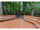 Backyard patio with fire pit, wood benches, and stone pathway to the manicured yard at 6208 Rocky Falls Rd, Charlotte, NC 28211