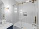 This bathroom features gold hardware, a tiled shower niche, and a glass door to the tub at 6208 Rocky Falls Rd, Charlotte, NC 28211