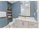 Stylist bathroom featuring a designer vanity with a marble countertop and gold fixtures at 6208 Rocky Falls Rd, Charlotte, NC 28211
