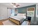 Inviting bedroom with natural light, stylish decor, a ceiling fan, and dark wood accents at 6208 Rocky Falls Rd, Charlotte, NC 28211