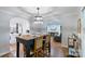 A beautifully decorated dining area with a unique light fixture and easy access to kitchen and living room at 6208 Rocky Falls Rd, Charlotte, NC 28211