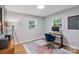 This office features two windows for plenty of natural light, a stylish rug, and wood flooring at 6208 Rocky Falls Rd, Charlotte, NC 28211