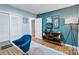 This office features a built-in bookcase, stylish decor, a blue accent wall, and plenty of natural light at 6208 Rocky Falls Rd, Charlotte, NC 28211