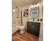 Bathroom featuring a tub shower, toilet, vanity with drawers, and unique light fixture at 7228 Rollingridge Dr, Charlotte, NC 28211
