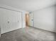Bedroom with neutral carpet, light walls, and double door closet at 7228 Rollingridge Dr, Charlotte, NC 28211