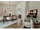 Bright dining area with modern chandelier, dining table set, and comfortable seating next to bar seating at 7228 Rollingridge Dr, Charlotte, NC 28211