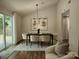 Cozy dining room featuring a modern chandelier, dining table set, and comfortable seating with sliding glass doors at 7228 Rollingridge Dr, Charlotte, NC 28211