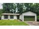 Charming single-story home with a green garage door and well-manicured lawn at 7228 Rollingridge Dr, Charlotte, NC 28211