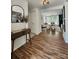Warm foyer featuring wood floors and an open view to the living area at 7228 Rollingridge Dr, Charlotte, NC 28211