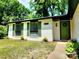 Inviting home featuring neat landscaping and a brightly colored front door at 7228 Rollingridge Dr, Charlotte, NC 28211