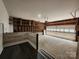 Unfinished garage with exposed studs offers ample storage and customization opportunities at 7228 Rollingridge Dr, Charlotte, NC 28211