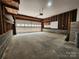 Spacious, unfinished garage with storage shelving awaiting your personal touches at 7228 Rollingridge Dr, Charlotte, NC 28211