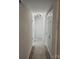 Hallway featuring neutral walls and flooring with a simple overhead light fixture and closet at 7228 Rollingridge Dr, Charlotte, NC 28211