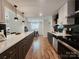 Bright kitchen featuring black and white cabinets, countertops, and stainless steel appliances with light floors at 7228 Rollingridge Dr, Charlotte, NC 28211