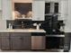 Charming kitchen featuring white cabinets, countertops, stainless steel appliances, and dark backsplash at 7228 Rollingridge Dr, Charlotte, NC 28211
