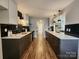 Modern kitchen featuring black and white cabinets, countertops, and stainless steel appliances with light floors at 7228 Rollingridge Dr, Charlotte, NC 28211