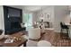 Bright living room with fireplace, dining area, and modern decor in neutral tones creates a welcoming atmosphere at 7228 Rollingridge Dr, Charlotte, NC 28211