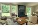Cozy living room featuring a black brick fireplace and views of the outdoors at 7228 Rollingridge Dr, Charlotte, NC 28211