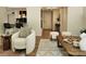 Bright living room featuring modern decor, plush seating, and stylish accents with light wood floors and soft rug at 7228 Rollingridge Dr, Charlotte, NC 28211