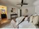 Bedroom featuring a ceiling fan, carpet, art, and a door to a bathroom at 7228 Rollingridge Dr, Charlotte, NC 28211