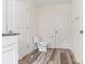 Half bathroom with wood look floors, white fixtures, and modern granite vanity at 7308 Rothmore St, Charlotte, NC 28215