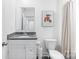 Well-lit bathroom featuring granite countertop, modern sink, and a toilet with storage, offering both style and functionality at 7308 Rothmore St, Charlotte, NC 28215