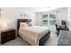 Cozy bedroom featuring a plush bed, stylish nightstand, and a bright window for natural light, perfect for relaxation at 7308 Rothmore St, Charlotte, NC 28215