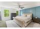 Stylish bedroom with a tufted headboard, accent wall, and natural light creating a cozy and inviting retreat at 7308 Rothmore St, Charlotte, NC 28215