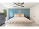 Well-lit bedroom featuring a tufted bed frame and an accent wall, creating a cozy and inviting retreat at 7308 Rothmore St, Charlotte, NC 28215