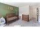 Well-organized Bedroom featuring a wooden crib, changing table dresser, and neutral decor, creating a serene atmosphere at 7308 Rothmore St, Charlotte, NC 28215