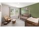 Charming Bedroom with wooden crib, changing table, rocking chair and an accent wall with a custom neon sign at 7308 Rothmore St, Charlotte, NC 28215